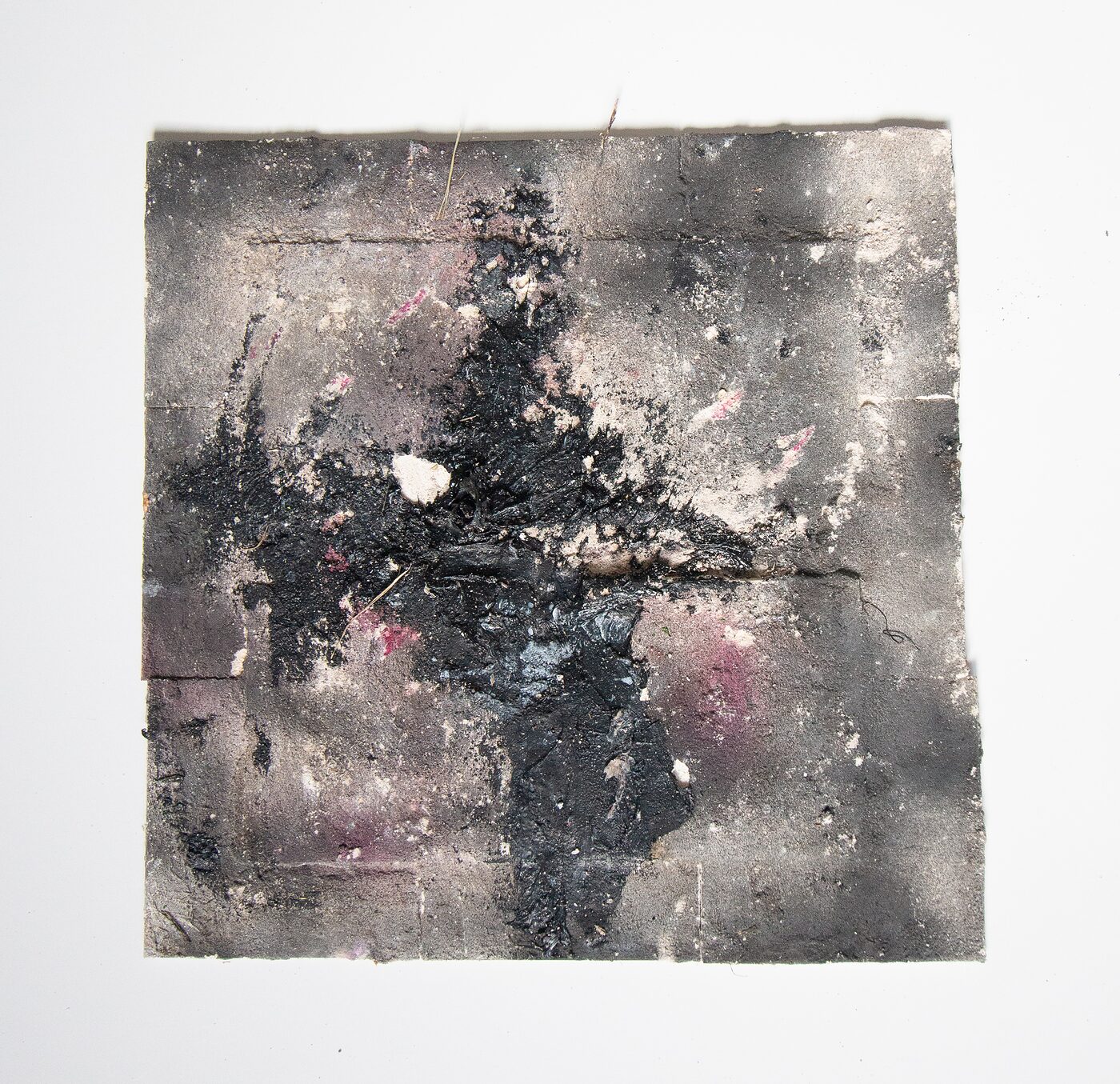 Square masonite. Heavy black asterisk of impasto erupting from the centre over a grey-brown ground, with magenta and pink stains bleeding through the surface and pale chalky deposits at the corners.