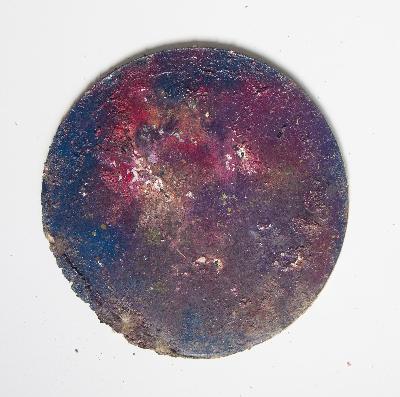 Circular masonite tondo. Deep cobalt and indigo across most of the disc with a magenta-crimson core flaring near the upper centre. Pitted edges, atmospheric depth.