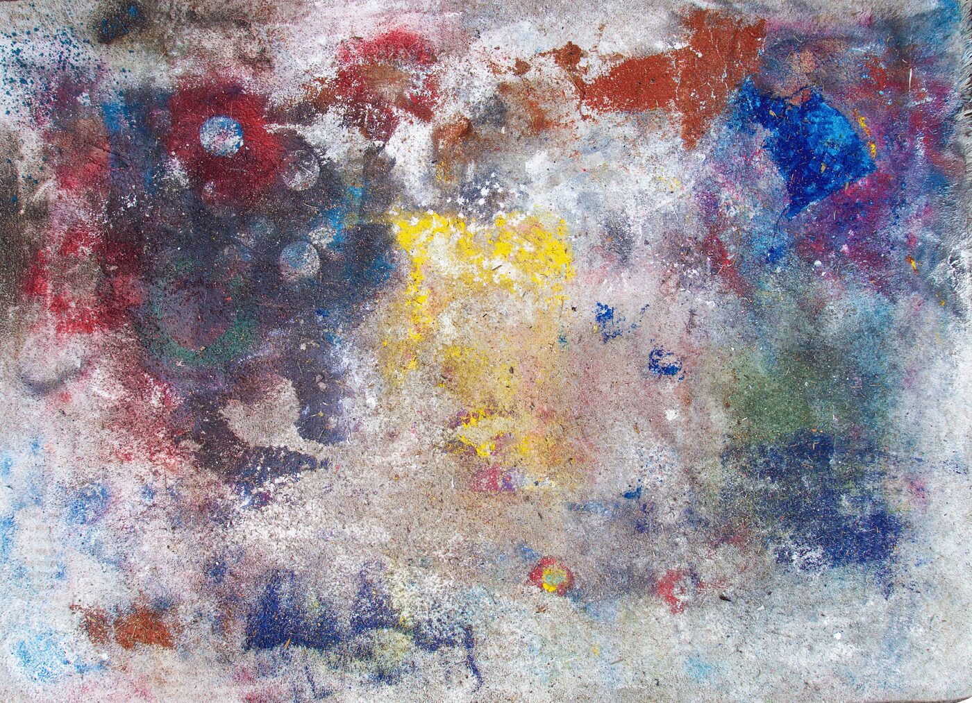Rectangular masonite in landscape format. Scattered chromatic events across a pale silvery ground: magenta and dark crimson at left, golden yellow centre, deep ultramarine upper right, rust-orange band across the top. Reads as a sky-chart.